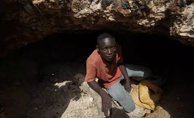 Bashir Rabiu, 19, poses for a photograph inside at an illegal lithium mining site in Paseli, Nigeria, Tuesday, Nov 5, 2024. (AP Photo/Sunday Alamba)