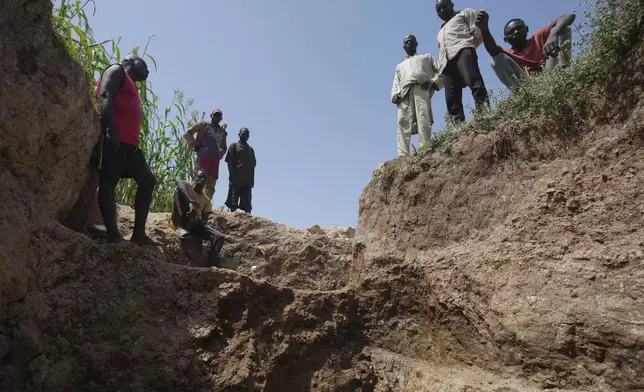 Workers stand at an illegal lithium mine in Paseli, Nigeria, Tuesday, Nov 5, 2024. (AP Photo/Sunday Alamba)