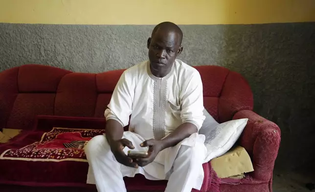 Aliyu Ibrahim, a lithium merchant, speaks with The Associated Press about his business in Nasarawa, Nigeria, Tuesday, Nov 5, 2024. (AP Photo/Sunday Alamba)