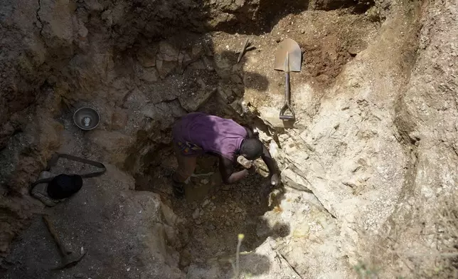 Yusuf Rabiu works at an illegal lithium mining site in Paseli, Nigeria, Tuesday, Nov 5, 2024. (AP Photo/Sunday Alamba)