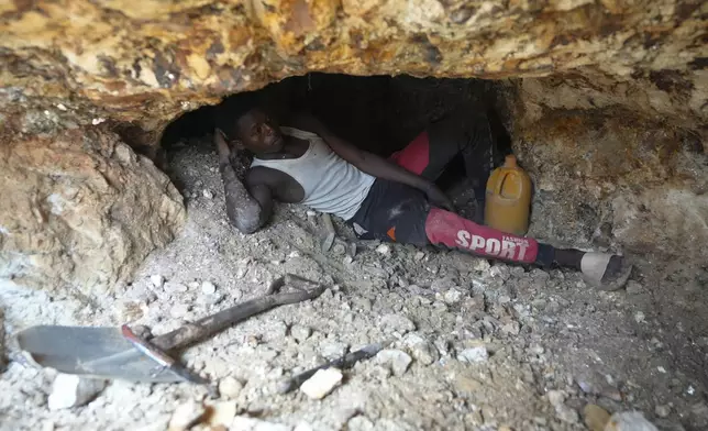 A worker takes a rest at an illegal lithium mining site in Paseli, north central Nigeria, Tuesday, Nov 5, 2024. (AP Photo/Sunday Alamba)