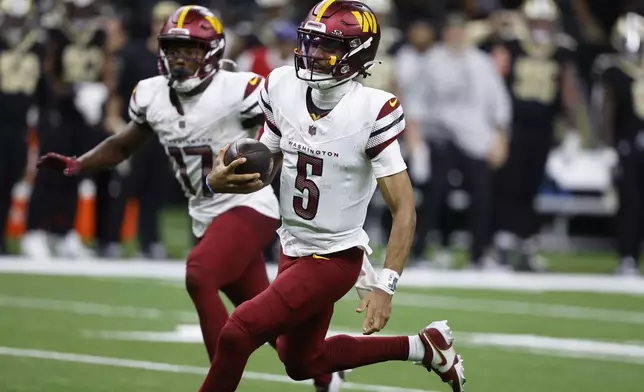 Washington Commanders quarterback Jayden Daniels (5) runs the ball in the second half of an NFL football game against the New Orleans Saints in New Orleans, Sunday, Dec. 15, 2024. (AP Photo/Butch Dill)