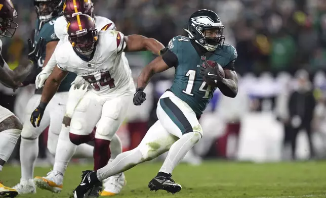 FILE - Philadelphia Eagles running back Kenneth Gainwell (14) runs with the ball during the second half of an NFL football game against the Washington Commanders Thursday, Nov. 14, 2024, in Philadelphia. (AP Photo/Matt Slocum, File)