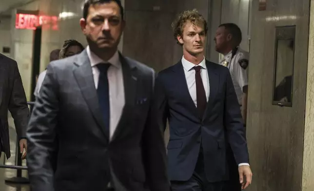 Daniel Penny, right, walks out of the courtroom, next to Thomas Kenniff, left, his lawyer, Wednesday, Dec. 4, 2024, in New York. (AP Photo/Heather Khalifa)