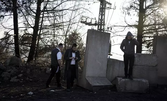 Ultra-Orthodox Jewish men tour northern Israel, near the border with Lebanon, during a ceasefire, Tuesday, Dec. 3, 2024. (AP Photo/Maya Alleruzzo)