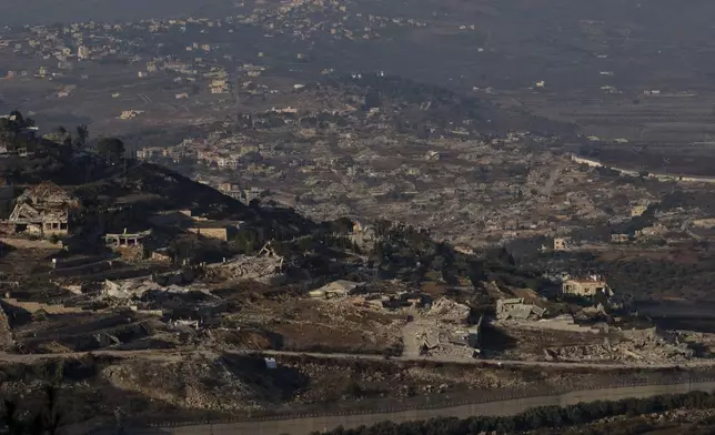 Destroyed buildings in the village of Kfar Kila, southern Lebanon, are seen from northern Israel, Tuesday, Dec. 3, 2024. (AP Photo/Maya Alleruzzo)