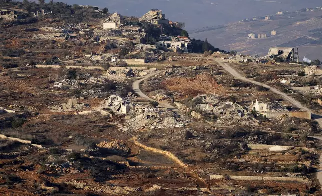 Destroyed buildings in the village of Kfar Kila, southern Lebanon, are seen from northern Israel, Tuesday, Dec. 3, 2024. (AP Photo/Maya Alleruzzo)