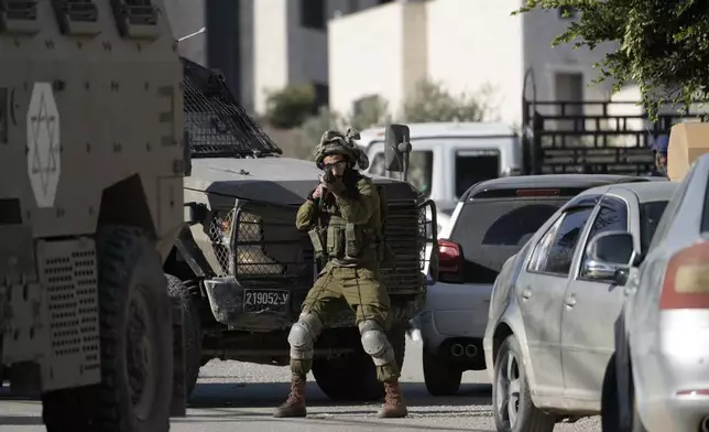 Israeli troops enter the complex of the Turkish hospital, where they searched for the bodies of those killed in an airstrike, in the West Bank city of Tubas, Tuesday Dec. 3, 2024. (AP Photo/Majdi Muhammad)