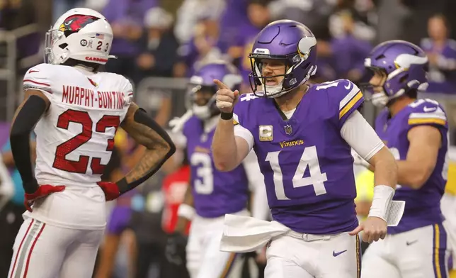 Minnesota Vikings quarterback Sam Darnold (14) celebrates after throwing a touchdown pass during the second half of an NFL football game against the Arizona Cardinals Sunday, Dec. 1, 2024, in Minneapolis. (AP Photo/Bruce Kluckhohn)