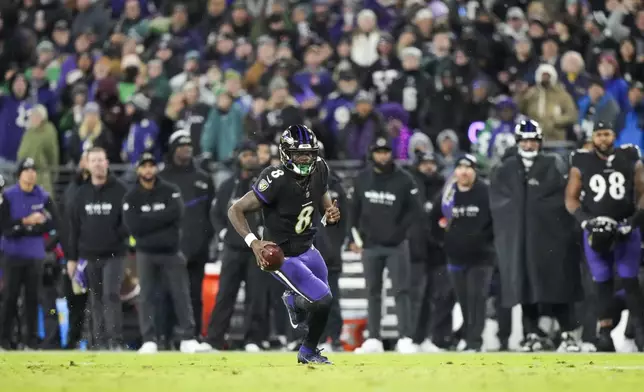 Baltimore Ravens quarterback Lamar Jackson runs with the ball against the Philadelphia Eagles during the first half of an NFL football game, Sunday, Dec. 1, 2024, in Baltimore. (AP Photo/Stephanie Scarbrough)