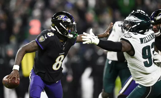 Baltimore Ravens quarterback Lamar Jackson (8) is pressured by Philadelphia Eagles defensive tackle Milton Williams (93) during the second half of an NFL football game, Sunday, Dec. 1, 2024, in Baltimore. (AP Photo/Nick Wass)