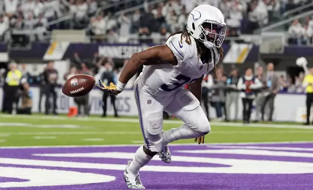 Minnesota Vikings running back Aaron Jones (33) celebrates after a 1-yard touchdown run during the second half of an NFL football game against the Chicago Bears, Monday, Dec. 16, 2024, in Minneapolis. (AP Photo/Abbie Parr)