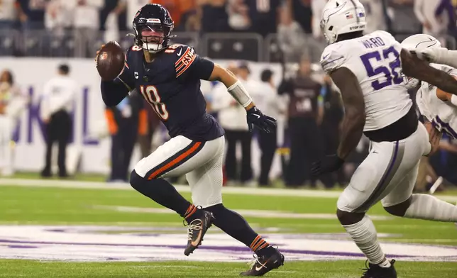 Chicago Bears quarterback Caleb Williams (18) runs from Minnesota Vikings linebacker Jihad Ward (52) during the first half of an NFL football game, Monday, Dec. 16, 2024, in Minneapolis. (AP Photo/Bruce Kluckhohn)