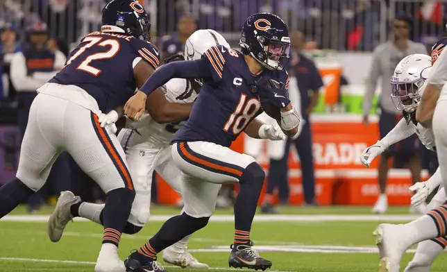 Chicago Bears quarterback Caleb Williams (18) runs up field during the first half of an NFL football game against the Minnesota Vikings, Monday, Dec. 16, 2024, in Minneapolis. (AP Photo/Bruce Kluckhohn)