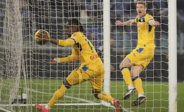 Atalanta's Ademola Lookman, left, celebrates after Atalanta's Marco Brescianini, right, scoring his side's opening goal during a Serie A soccer match between Lazio and Atalanta, at the Stadio Olimpico in Rome, Italy, Saturday, Dec. 28, 2024. (AP Photo/Alessandra Tarantino)