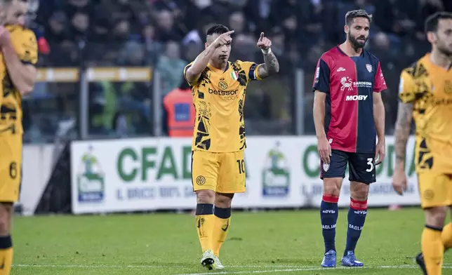 Inter Milan's Lautaro Martinez celebrates with teammates after scoring his side's second goal during the Serie A soccer match between Cagliari Calcio and Inter Milan at the Unipol Domus stadium in Cagliari, Italy, Saturday, Dec. 28, 2024. (Gianluca Zuddas/LaPresse via AP)