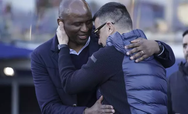 Genoa's head coach Patrick Vieira, left, and Empoli's head coach Roberto D'Aversa hug before the Serie A soccer match between Empoli and Genoa at the Carlo Castellani stadium in Empoli, Italy, Saturday, Dec. 28, 2024. (Marco Bucco/LaPresse via AP)