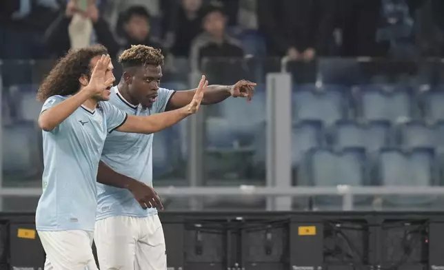 Lazio's Fisayo Dele-Bashiru, right, celebrates with teammates after scoring his side's opening goal during a Serie A soccer match between Lazio and Atalanta, at the Stadio Olimpico in Rome, Italy, Saturday, Dec. 28, 2024. (AP Photo/Alessandra Tarantino)