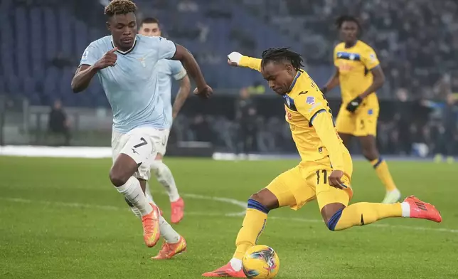 Atalanta's Ademola Lookman, right, duels for the ball with Lazio's Fisayo Dele-Bashiru during a Serie A soccer match between Lazio and Atalanta, at the Stadio Olimpico in Rome, Italy, Saturday, Dec. 28, 2024. (AP Photo/Alessandra Tarantino)