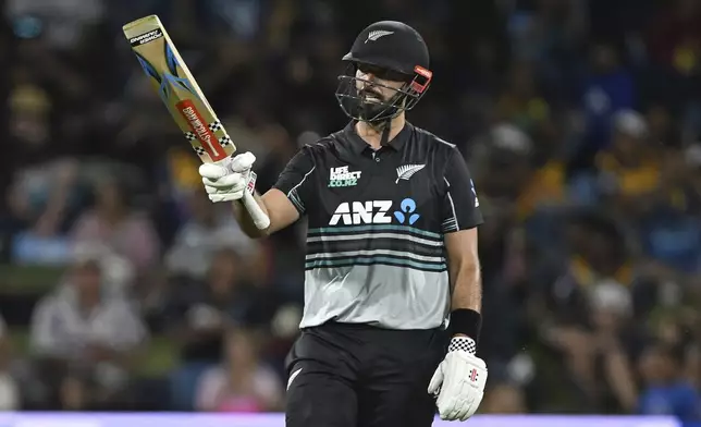 New Zealand's Daryl Mitchell celebrates scoring 50 runs, during the first Twenty20 international cricket match between New Zealand and Sri Lanka at Mt Maunganui, New Zealand, Saturday, Dec. 28, 2024. (Andrew Cornaga/Photosport via AP)