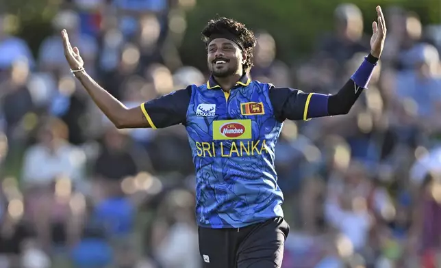 Sri Lanka's Avishka Fernando celebrates the wicket of New Zealand's Rachin Ravindra during the first Twenty20 international cricket match between New Zealand and Sri Lanka at Mt Maunganui, New Zealand on Saturday, Dec. 28, 2024. (Andrew Cornaga/Photosport via AP)