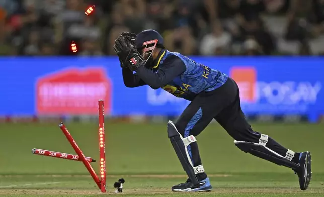 Sri Lanka's Kusal Mendis stumps New Zealand's Daryl Mitchell, during the first Twenty20 international cricket match between New Zealand and Sri Lanka at Mt Maunganui, New Zealand, Saturday, Dec. 28, 2024. (Andrew Cornaga/Photosport via AP)