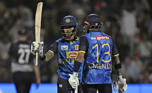 Sri Lanka's Pathum Nissanka celebrates scoring 50 runs, during the first Twenty20 international cricket match between New Zealand and Sri Lanka at Mt Maunganui, New Zealand, Saturday, Dec. 28, 2024. (Andrew Cornaga/Photosport via AP)