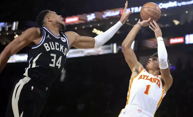 Atlanta Hawks forward Jalen Johnson (1) shoots against Milwaukee Bucks forward Giannis Antetokounmpo (34) during the first half of a semifinal game in the NBA Cup basketball tournament Saturday, Dec. 14, 2024, in Las Vegas. (AP Photo/Ian Maule)