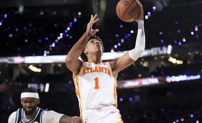 Atlanta Hawks forward Jalen Johnson (1) goes up to shoot against Milwaukee Bucks forward Bobby Portis, left, during the first half of a semifinal game in the NBA Cup basketball tournament Saturday, Dec. 14, 2024, in Las Vegas. (AP Photo/Ian Maule)