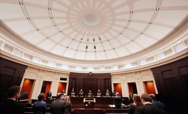 Justices of the Michigan Supreme Court enter their court at the Michigan Hall of Justice, Wednesday, Dec. 4, 2024, in Lansing, Mich. (AP Photo/Carlos Osorio)
