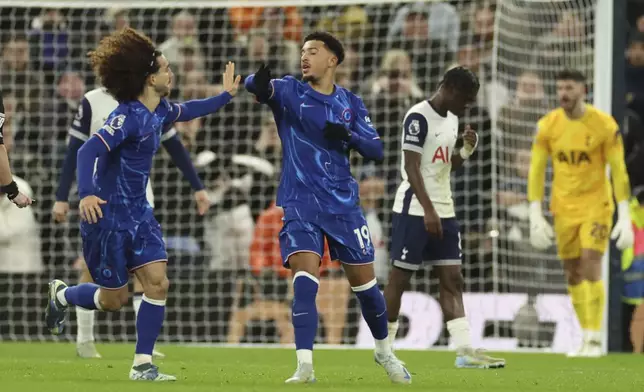 Chelsea's Jadon Sancho celebrates with his teammate Marc Cucurella after scoring his side's first goal during the English Premier League soccer match between Tottenham Chelsea, at the Hotspur stadium in London, Sunday, Dec.8, 2024. (AP Photo/Ian Walton)