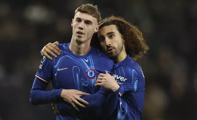Chelsea's Cole Palmer celebrates with his teammate Marc Cucurella after scoring his side's fourth goal during the English Premier League soccer match between Tottenham Chelsea, at the Hotspur stadium in London, Sunday, Dec.8, 2024. (AP Photo/Ian Walton)