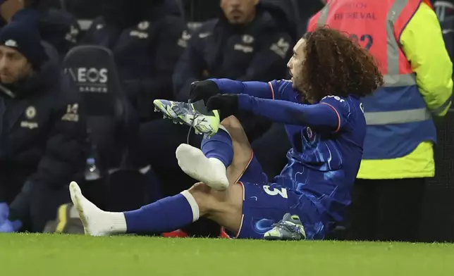 Chelsea's Marc Cucurella changes his shoes during the English Premier League soccer match between Tottenham Chelsea, at the Hotspur stadium in London, Sunday, Dec.8, 2024. (AP Photo/Ian Walton)