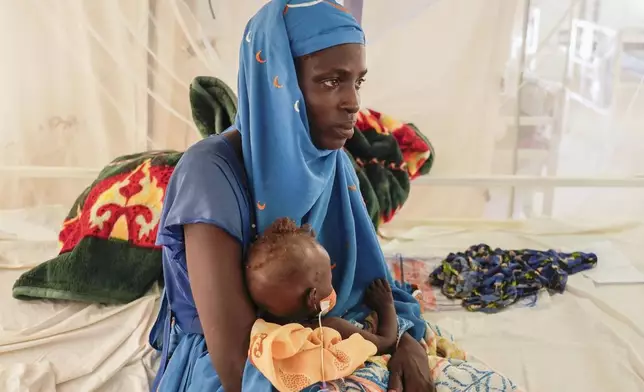 Halima Habdullha holds her 7-month-old severely malnourished daughter Kaltum Abakar in an MSF-run clinic in the Aboutengue displacement site near Acre, Chad, Friday, Oct 4. 2024. (AP Photo/Sam Mednick)