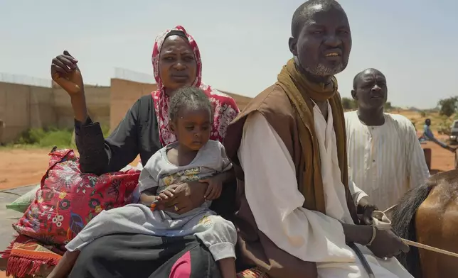 Ousmane Taher and his family cross from Sudan into Chad near Acre Sunday, Oct 6. 2024. (AP Photo/Sam Mednick)