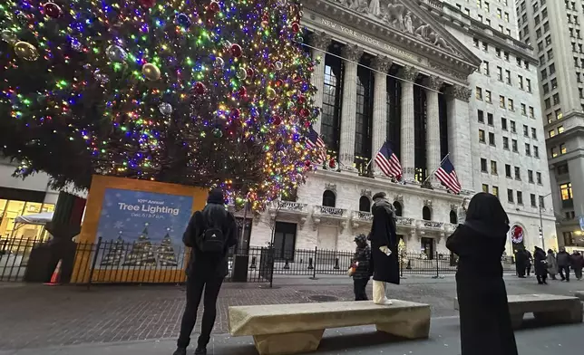 FIL:E - People photograph the New York Stock Exchange in New York's Financial District on Dec. 23, 2024. (AP Photo/Peter Morgan, File)