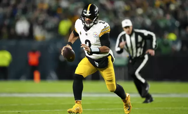 Pittsburgh Steelers quarterback Russell Wilson runs with the ball during the first half of an NFL football game against the Philadelphia Eagles on Sunday, Dec. 15, 2024, in Philadelphia. (AP Photo/Derik Hamilton)