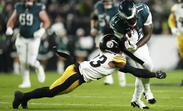 Philadelphia Eagles wide receiver A.J. Brown (11) is tackled by Pittsburgh Steelers safety Damontae Kazee (23) during the first half of an NFL football game Sunday, Dec. 15, 2024, in Philadelphia. (AP Photo/Derik Hamilton)