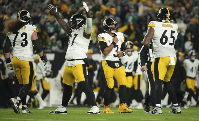 Pittsburgh Steelers quarterback Russell Wilson (3) reacts after a touchdown pass to teammate Pat Freiermuth during the first half of an NFL football game against the Philadelphia Eagles on Sunday, Dec. 15, 2024, in Philadelphia. (AP Photo/Matt Slocum)