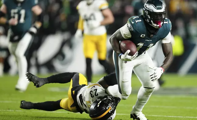 Philadelphia Eagles wide receiver A.J. Brown (11) is tackled by Pittsburgh Steelers safety Damontae Kazee (23) during the first half of an NFL football game Sunday, Dec. 15, 2024, in Philadelphia. (AP Photo/Derik Hamilton)