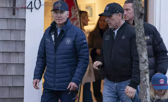 President Joe Biden and son Hunter Biden walk in downtown Nantucket Mass., Friday, Nov. 29, 2024. (AP Photo/Jose Luis Magana)