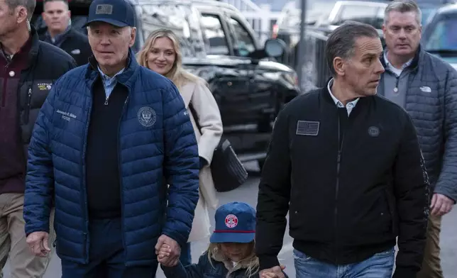 President Joe Biden with his son Hunter Biden and his grandson Beau walk in downtown Nantucket Mass., Friday, Nov. 29, 2024. (AP Photo/Jose Luis Magana)