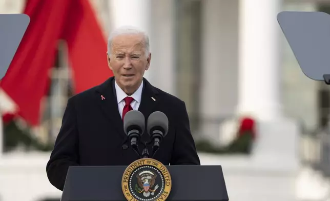 President Joe Biden speaks on the South Lawn of the White House during a ceremony to commemorate World AIDS Day with survivors, their families and advocates, Sunday, Dec. 1, 2024, in Washington. (AP Photo/Manuel Balce Ceneta)