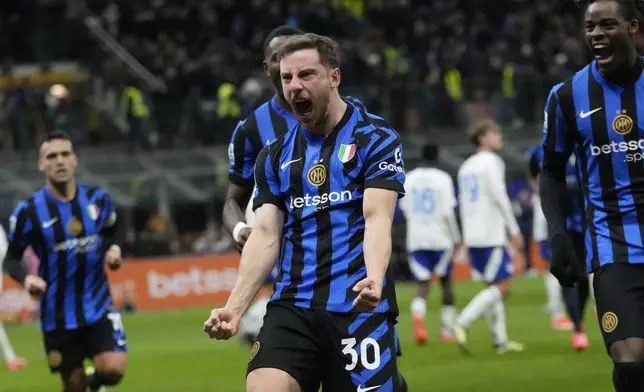 Inter Milan's Carlos Augusto, center, celebrates with his teammates after scoring against Como during a Serie A soccer match between Inter Milan and Como at the San Siro stadium in Milan, Italy, Monday, Dec. 23, 2024. (AP Photo/Luca Bruno)