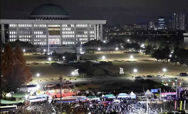 People gather to demand South Korean President Yoon Suk Yeol to step down in front of the National Assembly in Seoul, South Korea, Wednesday, Dec. 4, 2024. (Kim Do-hoon/Yonhap via AP)