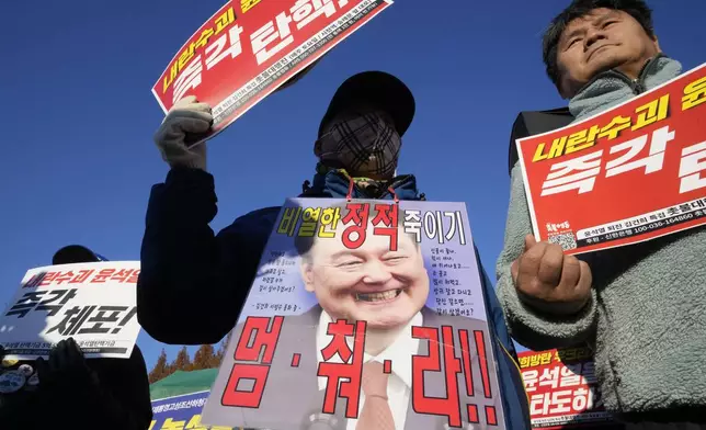 Protesters attend a rally to demand South Korean President Yoon Suk Yeol to step down in front of the National Assembly in Seoul, South Korea, Wednesday, Dec. 4, 2024. The signs read "Stop." (AP Photo/Ahn Young-joon)