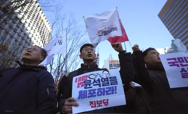 South Koreans shout slogans with signs reading "Arrest Yoon Suk Yeol" during a rally in Seoul, South Korea, Wednesday, Dec. 4, 2024. (AP Photo/Lee Jin-man)