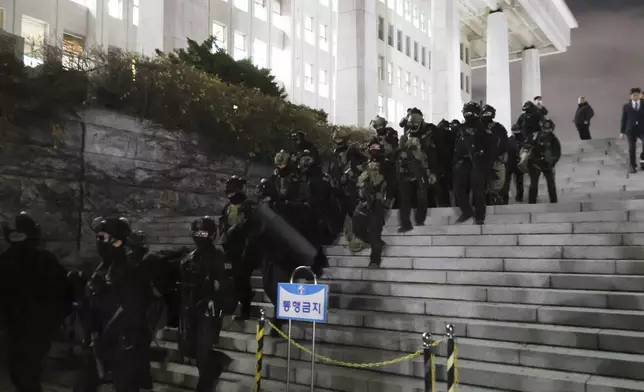 South Korean martial law soldiers leave the National Assembly in Seoul, South Korea, Wednesday, Dec. 4, 2024. (Kim Ju-sung/Yonhap via AP)