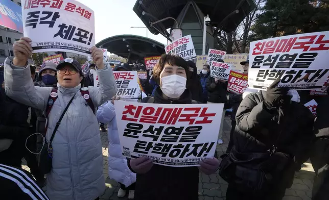 Members of main opposition Democratic Party stage a rally against South Korean President Yoon Suk Yeol in front of the National Assembly in Seoul, South Korea, Wednesday, Dec. 4, 2024. The signs read "Let's impeach Yoon Suk Yeol ." (AP Photo/Ahn Young-joon)