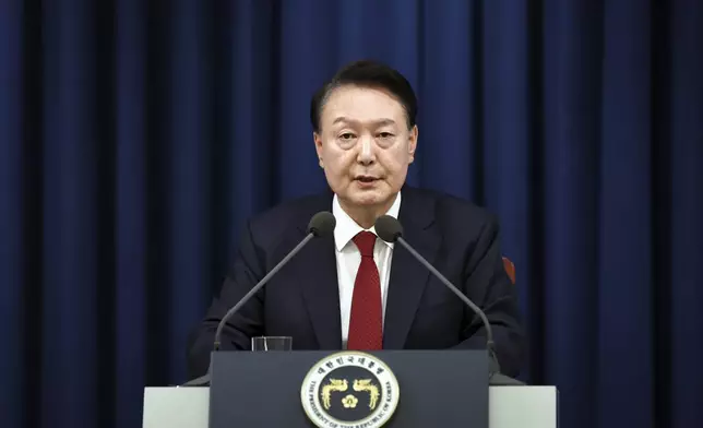 In this photo provided by South Korea Presidential Office, South Korean President Yoon Suk Yeol speaks during a press briefing at the presidential office in Seoul, South Korea, Tuesday, Dec. 3, 2024. (South Korea Unification Ministry via AP).